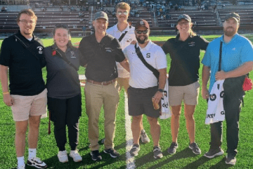 MS Athletic Training students posing for a photo on a football field