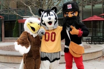 Bald Eagle, Husky, and Mountie mascots pose together