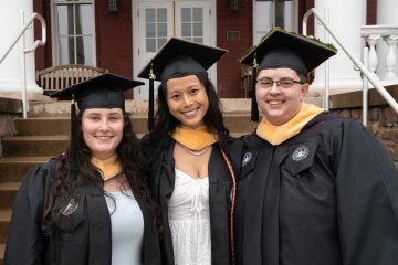 Three MSW graduates in front of Carver Hall