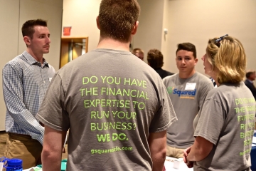 A group of G-Squared Partner recruiters speak with students at a recent career expo.