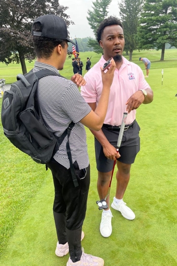 Toron James interviews Nakobe Dean while on assignment this summer for his internship.