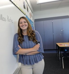 MEd Reading student standing at a white board