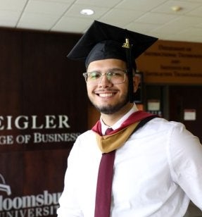 MBA Student standing in Sutliff Hall