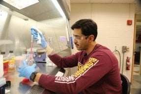 A CU-Bloomsburg Health Sciences alum in a chemistry lab