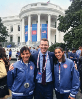 Adam Adrasko with artistic swimming team members