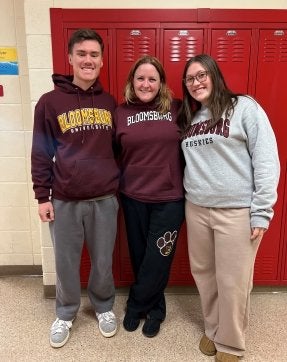 Cathy Zavacki '99 with two of her students