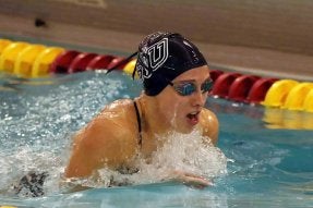 Julie Marchioni swimming as a Husky.