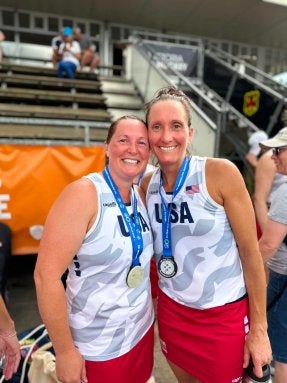 Mandy (Daschbach) Mowry '07 (left) Rebecca (Steffen) Newcomer '06 (right) celebrate earning silver medals at the 2026 World Masters Hockey World Cup.