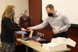 Dr. Carolyn LaMacchia (L) Receives Credential from Jonathan Hedrick (R). Dr. Lisa Stallbaumer-Beishline (C) is the TALE Director