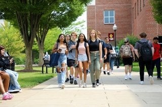 A group of students walking on campus.