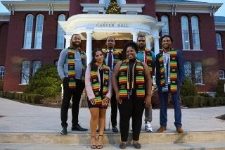A group of people standing outside. 