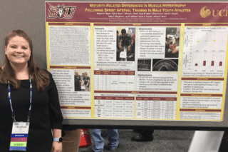 A girl standing next to an information board. 