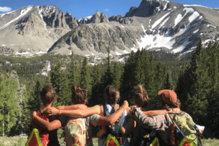 A group of girls side hugging. 
