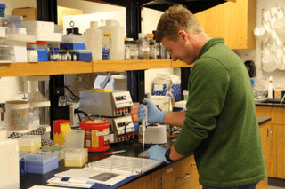 A man working in a lab setting.