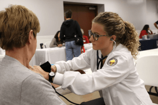 A nurse practicing on a patient.