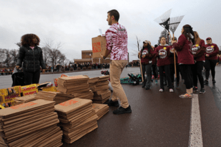 A group of people with boxes. 