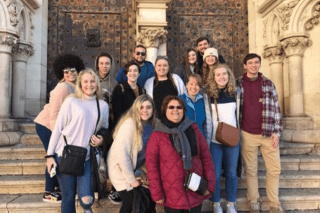A group standing on a staircase. 