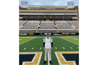 A man standing on a football field. 