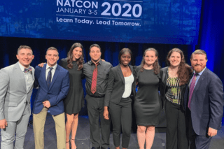 A group of people standing together on stage. 