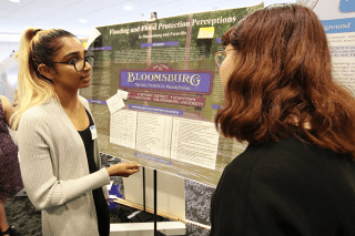 Two people looking at an information board. 