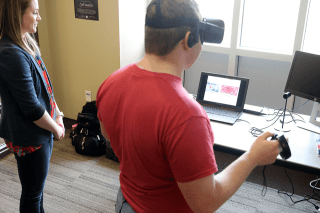 Two people looking at a computer.