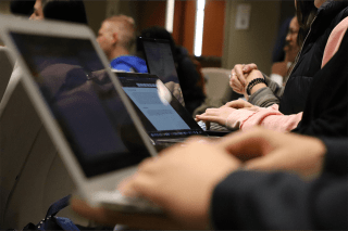 A closeup of people working on computers.