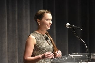 Rachael Denhollander standing at a podium. 