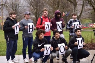 A group of people holding letters that spell out Thank You