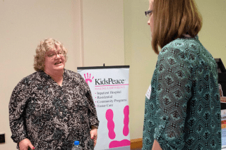 A representative from Kids Peace speaks with a student at a recent Career Expo