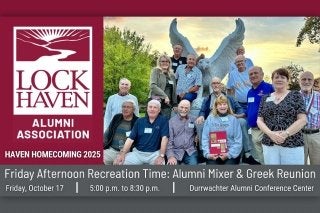 Lock Haven Alumni posing in front of Bald Eagle statue.