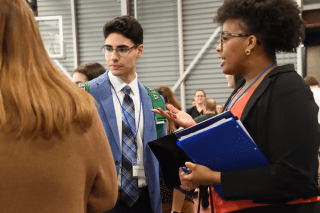 Two education students visit with employers at a recent Education Career Expo