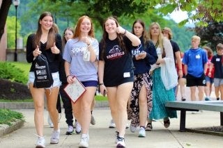 students walk on mansfield's campus