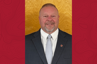 headshot of Rod Pusell on red background