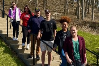 A group of students standing on a staircase. 
