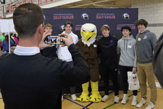 Accepted Lock Haven students stand with the bald eagle mascot at accepted student day