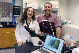 Julie Marchioni and Michael Borland in a chemistry lab.
