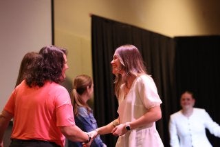 A CU-Bloomsburg student receives her pin during the teacher induction and pinning ceremony.