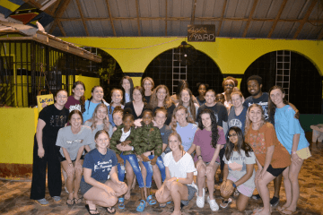 A group of people standing together for a photo. 
