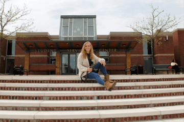 A girl sitting on a staircase. 