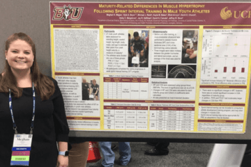 A girl standing next to an information board. 