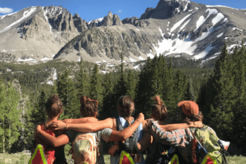 A group of girls side hugging. 