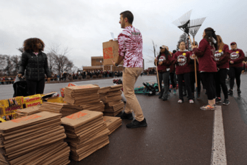 A group of people with boxes. 