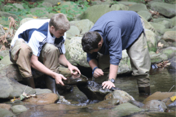 Watershed faculty student with rocks