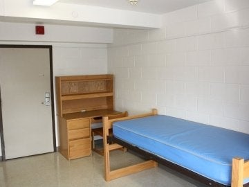 Columbia Hall bedroom showing a bed, desk, chair and door.