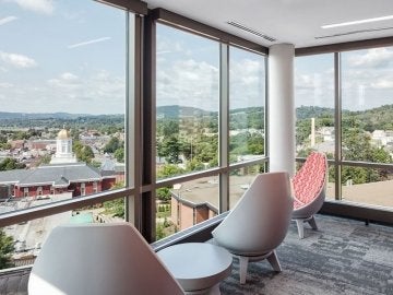 Egg chairs looking out large windows at Carver Hall and the town of Bloomsburg from David Soltz Hall