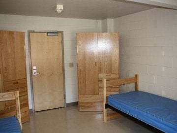 Beds and closets in a residence hall room of Elwell Hall