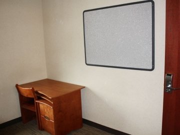 Bedroom of Jessica Kozloff Apartments showing desk and chair