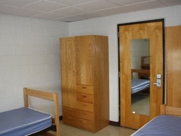 Lycoming Hall room showing two beds, two closets and the door.
