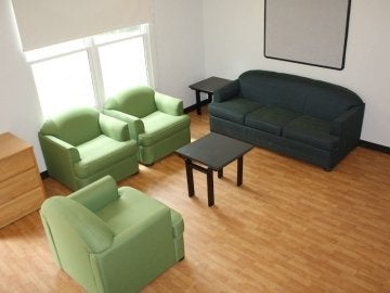 Couch, chairs and tables in the living room of a Mount Olympus Apartment