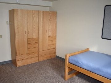 Bedroom of Montgomery Place Apartments showing two closets and bed